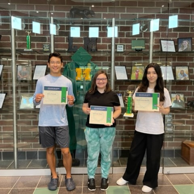 students smiling holding certificate